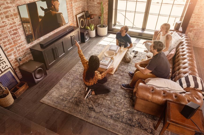 klipsch_flexus_core_300_bk_and_two_sub_200_in_living_room_with_group_of_friends_interacting_in_front_of_tv_2000x1333.jpg