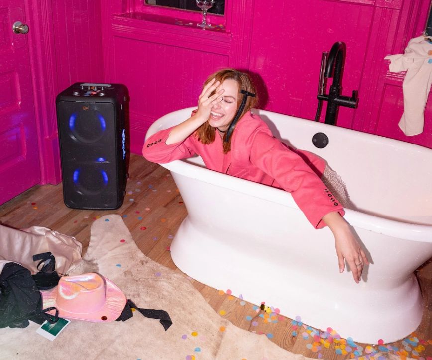 klipsch_party_speakers_vibe_woman_laughing_sleepily_fully_clothed_in_a_bathtub_2000x1670.jpg